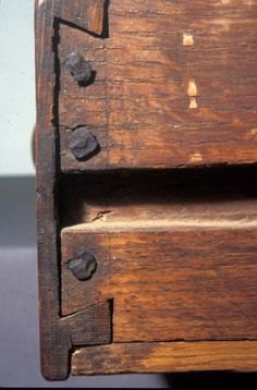 an old wooden dresser with metal knobs