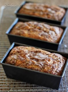 three loafs of cinnamon bread cooling on a wire rack