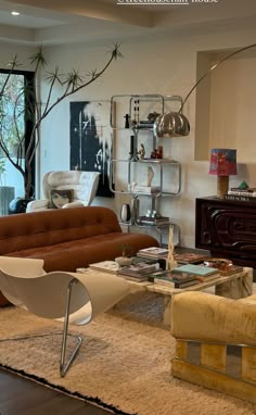 a living room filled with furniture and a large window covered in glass door frames to the outside