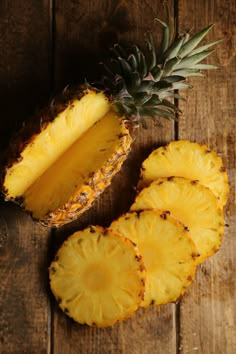 the pineapple is cut in half and ready to be eaten on the wooden table