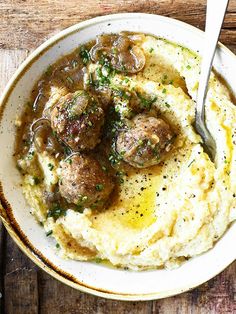 a bowl filled with mashed potatoes and meatballs