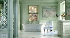 an elegant bathroom with green walls and marble flooring is pictured in this image, the tub has been painted pale green