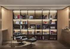 a chair and desk in front of a book shelf