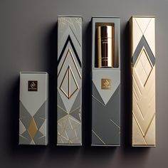 three boxes with gold and silver designs on the sides, one has a bottle in it