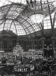 an old black and white photo of the inside of a building with many signs on it