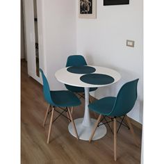 a white table with four blue chairs around it