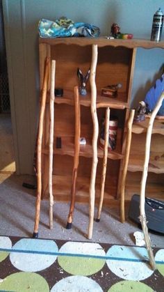 a book shelf made out of sticks and some other things on the floor next to it