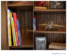 a book shelf with books and a toy airplane on it's top, next to a photograph of an older model plane