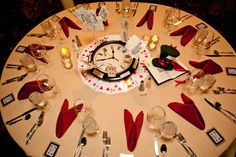 the table is set up with red napkins and silverware for an elegant valentine's day celebration