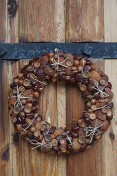 a wreath is hanging on the side of a wooden door