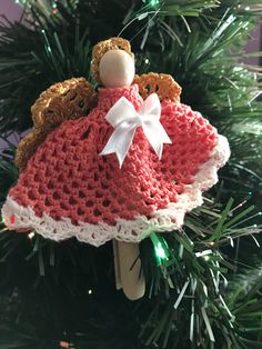 a crocheted christmas ornament with a teddy bear on it's back