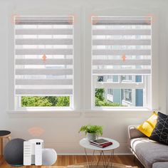 the living room has two windows with blinds on them and a coffee table in front of it