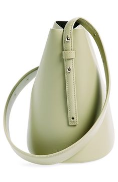 A clean-lined minimalist design defines this just-the-essentials bucket bag crafted of smooth calfskin leather. The adjustable strap is wider in the middle for a comfortable carry, either in hand or over the shoulder. Magnetic-snap closure Adjustable shoulder strap Structured silhouette with flat base for stability Leather Made in Italy Designer Handbags Black Owned/Founded Chic Bucket Bag With Leather Lining, Smooth Grain Bucket Bag For Work, Chic Bucket Bag With Smooth Grain, Modern Soft Leather Bucket Bag, Chic Smooth Grain Bucket Bag, Modern Bucket Bag With Smooth Grain For Daily Use, Modern Bucket Bag With Leather Lining For Work, Leather-lined Bucket Bag For Work, Leather Lined Bucket Bag For Work