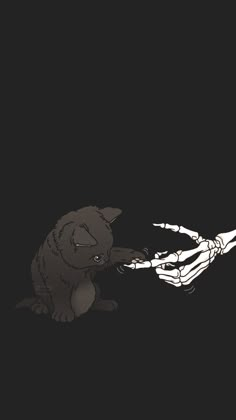 a skeleton hand reaching out to a cat that is biting it's paw in the dark