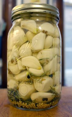 a jar filled with onions on top of a wooden table