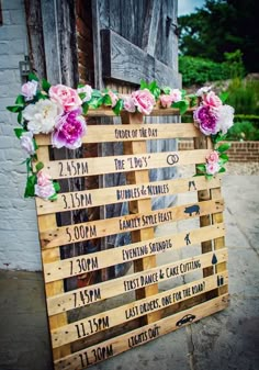 a wooden sign with flowers on it that reads code of the day and date of each month