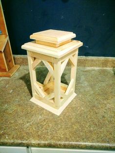 a small wooden table sitting on top of a counter