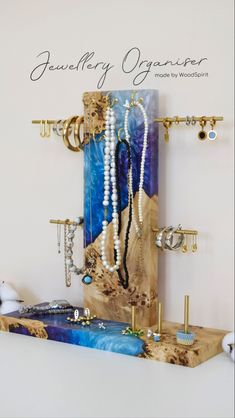 a wooden shelf with jewelry on it