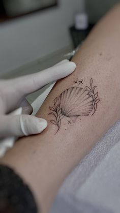 a woman's arm with a tattoo on it and a flower in the middle