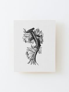 a black and white drawing of a fish with flowers on it's back side