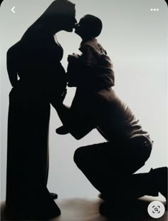 a man kissing a woman in front of a black and white photo with the word love on it