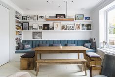 a living room filled with furniture and pictures on the wall