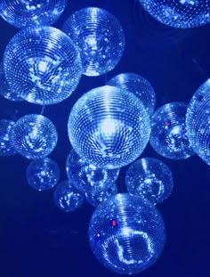 many clear bubbles floating in the air on a black background with blue lighting behind them