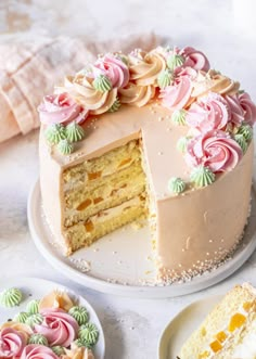 there is a cake that has been cut into pieces and served on the table with other desserts