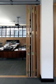 an open wooden door in front of a desk