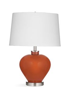 an orange table lamp with a white shade