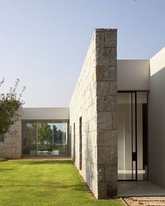 an exterior view of a house with grass and trees