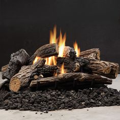 an outdoor fire pit with logs and rocks