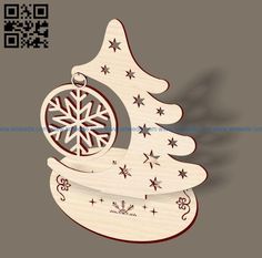 a laser cut christmas tree ornament with snowflakes