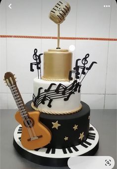 a three tiered cake with musical instruments on it