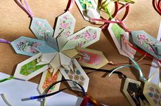 several origami flowers with ribbons attached to them