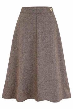 Our wool blend Herringbone skirt is inspired by the flared designs of the 1940s and 50s. Drawn from an era of classic silhouettes and 1940s glamour, this sophisticated and feminine piece will transport you back in time. The knee-length a-line skirt defined the post-war era of the late 40s and 50s. Its beautifully flowing shape flattered the wearer and helped create the hourglass shape so desired at the time. The wool blend is practical and durable, adding to the drape of the skirt and giving it perfect movement, whilst decorative details such as the Curozo button adds another delicate touch. Our Herringbone skirt is perfect to wear with a blouse for classic vintage chic or a sweater for the cooler months.  Visit our blog page to see how we developed our skirt design.  * Corozo button and z