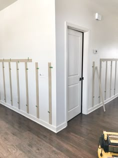 an empty room with hard wood flooring and white paint on the walls is being painted