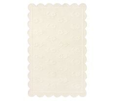 a white placemat with scalloped edges and stars on it, against a white background