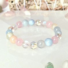 "This beautiful & powerful healing crystal bracelet is made with natural crystal beads of Rose Quartz, Aquamarine, Aura Quartz, Morganite and Moonstone.  The Abundance healing crystal bracelet combines key high vibrational crystals specifically designed to heal your heart and help you to manifest abundance, it will support you in letting go of the past and embracing your true self, you will feel genuine love for yourself and love for life, you will regain the energy to take on new adventures and Rose Quartz Gemstone Beads Bracelet For Meditation, Hand-strung Rose Quartz Crystal Bracelet For Healing, Spiritual Rose Quartz Crystal Bracelet With 8mm Beads, Spiritual Rose Quartz Crystal Bracelet For Healing, Spiritual Rose Quartz Bracelet With 8mm Beads, Spiritual Rose Quartz Beaded Crystal Bracelet, Spiritual Beaded Rose Quartz Crystal Bracelet, Heal Your Heart, Girly Bracelets