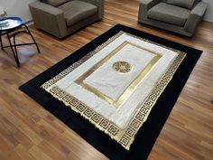 a living room with two chairs and a rug on the floor