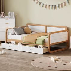 a child's bed with drawers underneath it