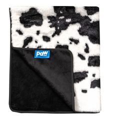 a black and white animal print blanket with the word pom written in blue on it