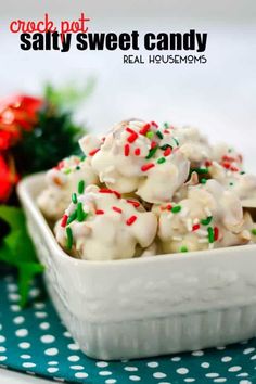 a white bowl filled with candy canes on top of a blue and white table cloth