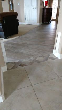 an empty living room with hard wood floors