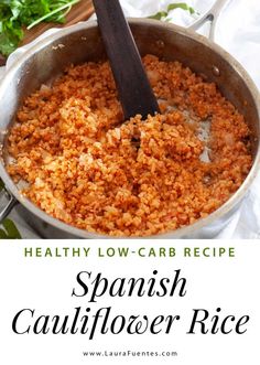 spanish cauliflower rice in a pan with a wooden spoon