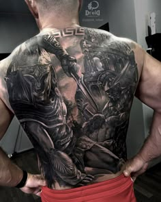 a man with tattoos on his back