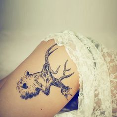 a woman with a deer head tattoo on her arm