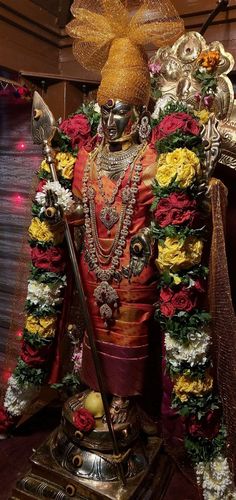 the statue is decorated with flowers and other decorations