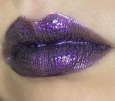 Spellbound is an enchanting royal purple lipgloss with a slight black shift and a hint of pink shimmer. Layer this gloss up on top of itself or a black liquid lipstick for maximum opacity. Made with pearlescent synthetic mica powder, and Coconut and Vitamin E oil for a smooth non-sticky gloss. It comes in Candy Apple flavored or Unscented in a 5ml tube.  (Vegan and cruelty free) Purple Lipgloss Aesthetic, Purple Lipgloss, Plum Glossy Lips, Black Liquid Lipstick, Purple Lip Gloss, Purple Glossy Lips, Bright Purple Lipstick, Neon Lips, Shimmer Lipstick