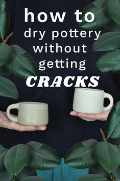 someone holding two mugs in their hands with the words how to dry pottery without getting cracks